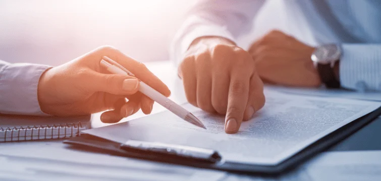 two people checking a document