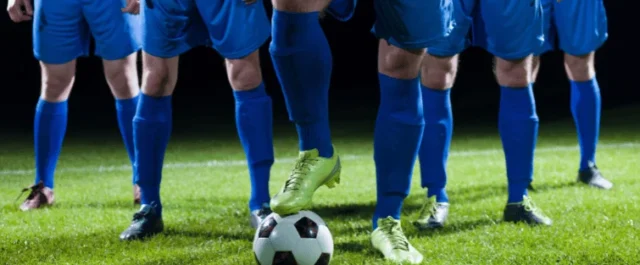 Five soccer players in a stadium