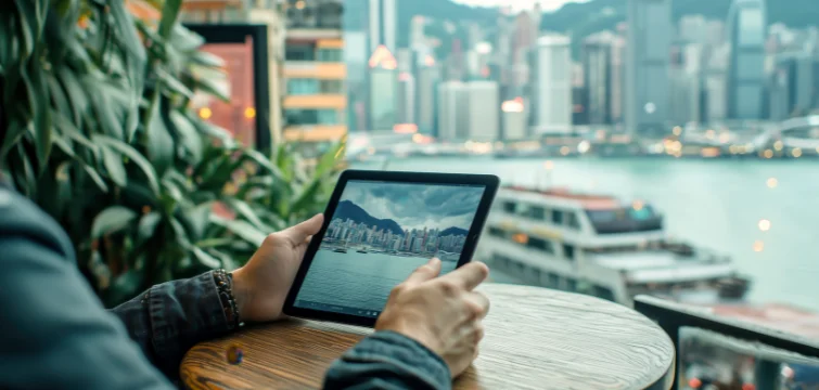 person working on a tablet with a marina in the background
