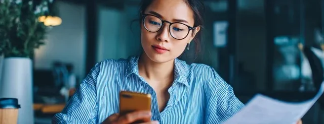 a woman checks her salary on her phone